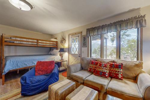 a bedroom with a bunk bed and a couch at Deer Mountain Lodge South in Estes Park