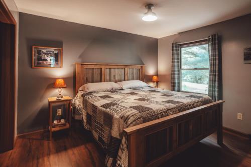 a bedroom with a large bed and a window at Patriot Cottage at American Heartland Cabins in Rockbridge