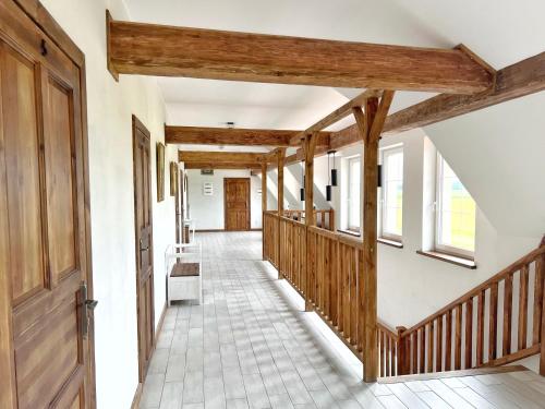 a hallway in a house with wooden beams at Brzozowy Ług Pensjonat 