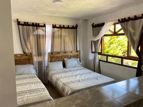 a bedroom with two beds and a window at Villa Sofia in Tlatlauquitepec