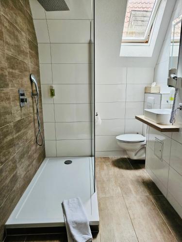 a bathroom with a shower and a toilet at Gala Hotel in Pforzheim