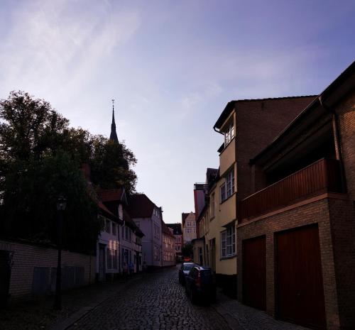 une rue vide dans une ville avec une église dans l'établissement Koje Sansibar, à Flensbourg