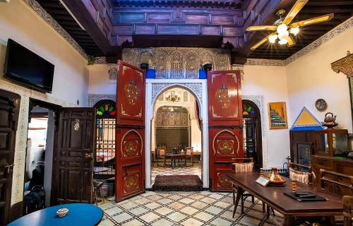 sala de estar con mesa y techo en Fes Antique Hostel en Fez