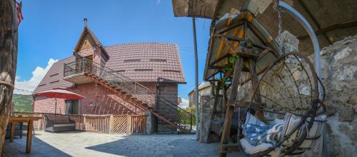 a building with a staircase and a building with a roof at Dom Adonis in Dilijan
