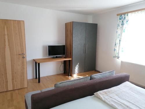 a living room with a couch and a cabinet at Apartment Anna im Mostviertel in Seitenstetten Markt