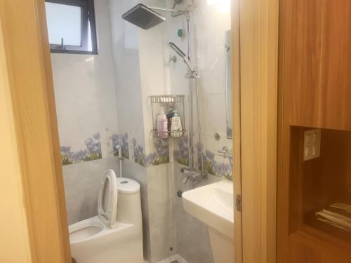 a bathroom with a shower and a toilet and a sink at GRAD Dai Thanh Hotel in Hanoi