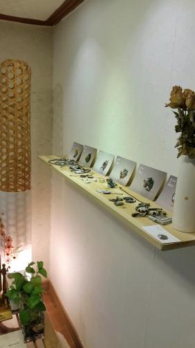 a shelf with pictures of flowers on a wall at Lydia Craft Guesthouse in Seoul
