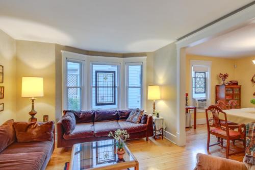 a living room with a couch and a table at Historic Home with Sunroom - 5 Mi to Lambeau Field! in De Pere