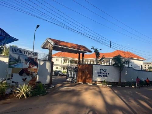 a building with a sign on the side of a street at Infinity Hotel Kampala in Kampala