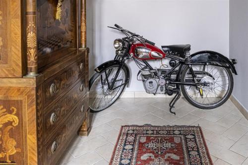 a motorcycle parked in a room with a rug at B&B Corte dei Ducati in Comacchio