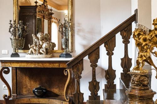 a staircase with a mirror and some vases on it at B&B Corte dei Ducati in Comacchio