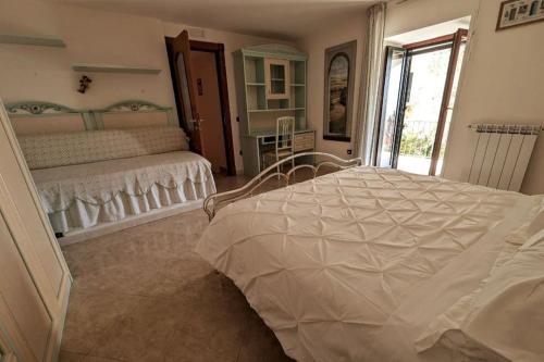 a bedroom with two beds and a window at Il barocco sulla roccia in Cetara