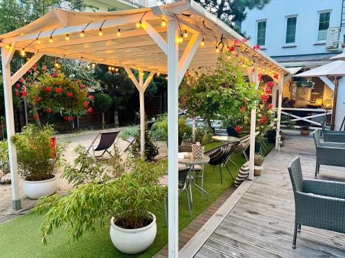 a wooden pergola with lights on a patio at Rezydencja Pod Tężnią & SPA in Inowrocław