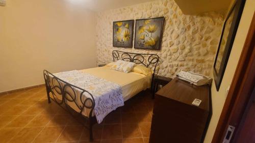 a small bedroom with a bed and a table at Angelo’s villa in Avliótai