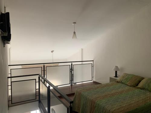 a bedroom with a bed and a balcony with a bed sqor at Loft Pedro Méndez 20408C in Posadas