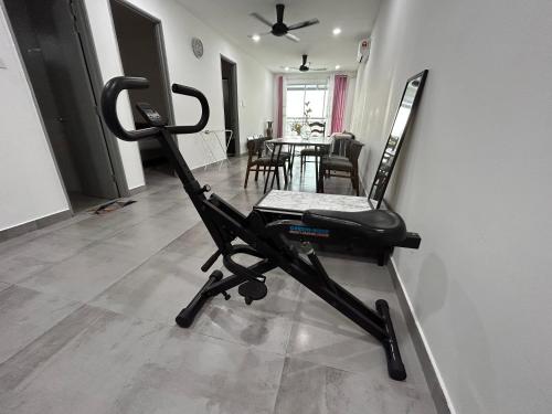 a black exercise bike sitting on the floor in a room at P3 Great value, cozy, convenient in city! in Kuching