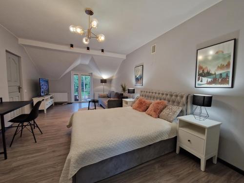 a bedroom with a bed and a living room at Seliu 25 Homestay Apartment poilsio namai in Šiauliai