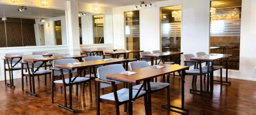 a row of tables and chairs in a restaurant at Vänerport Lakefront Hotell in Mariestad