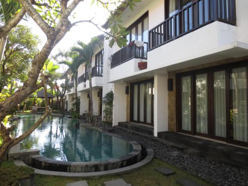 a swimming pool in the courtyard of a building at Seminyak TownHouse in Legian