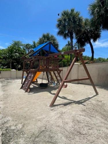 a playground with a slide in the sand at #44 Plantation Village in George Town