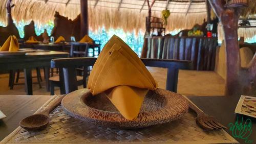 a hat sitting on top of a table in a restaurant at Yala Beddegama Eco in Kataragama