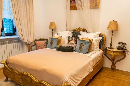 a bedroom with a large bed with pillows at Conacul Coroanei Luxury Boutique Hotel in Bucharest