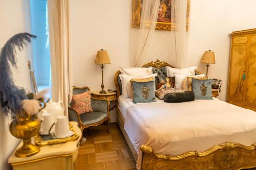 a bedroom with two beds and a chair at Conacul Coroanei Luxury Boutique Hotel in Bucharest