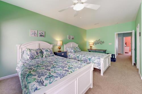 a bedroom with two beds and a ceiling fan at Oyster Bay Villas --- 20411 Jeb Dr, Unit #36 in Rehoboth Beach