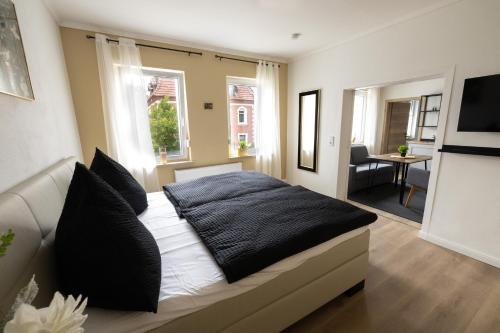 a bedroom with a bed with black and white pillows at sehusa living in Seesen
