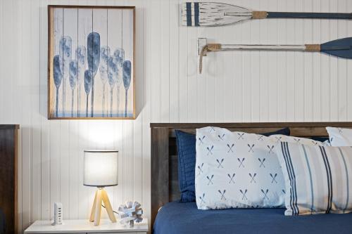 a bedroom with a blue bed with a lamp on a table at Lakefront, Fireplace Home Near Silver Dollar City in Kimberling City
