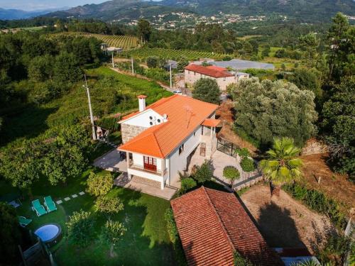 an overhead view of a white house with an orange roof at Refúgio dos 3 Passos in Lanhas