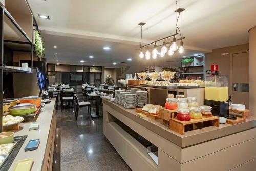a restaurant with a buffet line of food at Full Jazz by Slaviero Hotéis in Curitiba