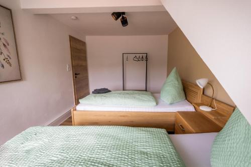 a small room with two beds and a mirror at sehusa living in Seesen