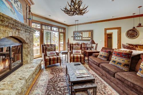 a living room with a couch and a fireplace at Ski-in Ski-out 1 BdrDen in exclusive Horizon Pass condo in Avon