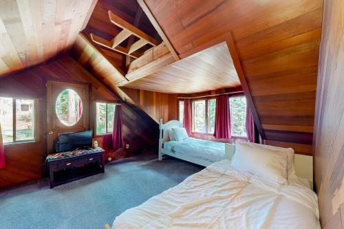 a bedroom with a bed in a room with wooden walls at Sierra Secret in Soda Springs