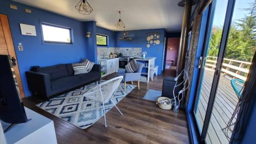a living room with blue walls and a couch at Casa Pascuala in Dalcahue