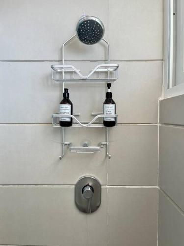 a bathroom with three bottles of wine on the wall at REEF Beachfront 3BDR apartment by CASA PARAISO in Cancún