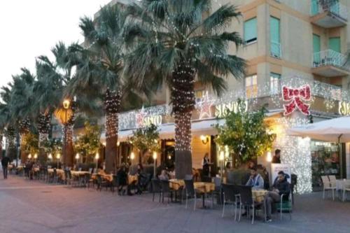 a group of palm trees in front of a building at La Casa di Daniela in Lido di Ostia