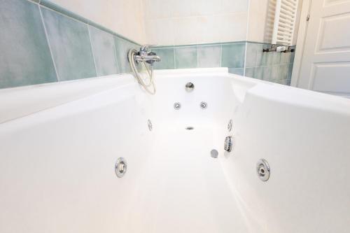 een wit bad in de badkamer bij NEW - La Casa di Daniela in Lido di Ostia