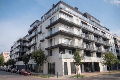 an apartment building with balconies on a street at K111 Klapka Apartment in Budapest