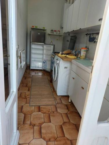 a small kitchen with a washer and dryer in it at Casa nel centro storico a Loreto, 2 km dal mare in Loreto
