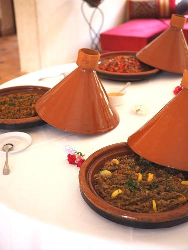 a table with three plates of food on it at Paradis Nomade in Azrarag