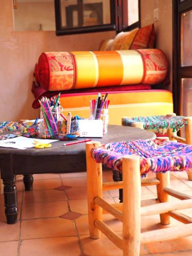 a table and two chairs in a room with a bed at Paradis Nomade in Azrarag