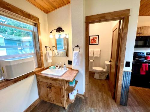 a bathroom with a sink and a toilet at Glacier's Edge Cabins in Columbia Falls