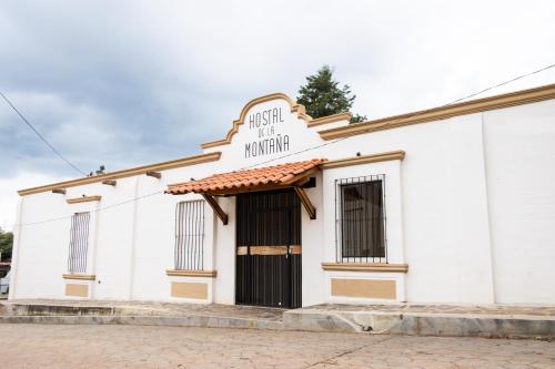 a white building with a sign that reads irish hospital monitor at Hostal de la Montaña in Mazamitla