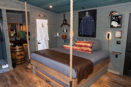 a bedroom with a swing bed in a room at "Air Fort One" Aviation-Themed Luxury Treehouse Near Dollywood & Pigeon Forge in Sevierville