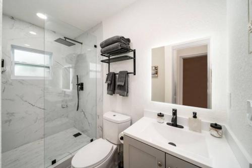 a bathroom with a toilet and a shower and a sink at Mango Lovers Zen Beach Retreat w Hot Tub in Fort Lauderdale