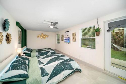 a bedroom with a bed and a window at Mango Lovers Zen Beach Retreat w Hot Tub in Fort Lauderdale