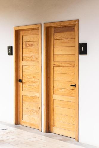 two wooden doors are open in a room at Hostal de la Montaña in Mazamitla