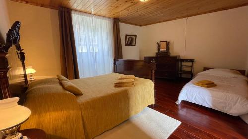 a bedroom with two beds and a window at A Vista dos Verdes in Furnas